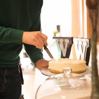 Closeup of the resident Ex Ordo baker, Liam, cutting into one of his creations